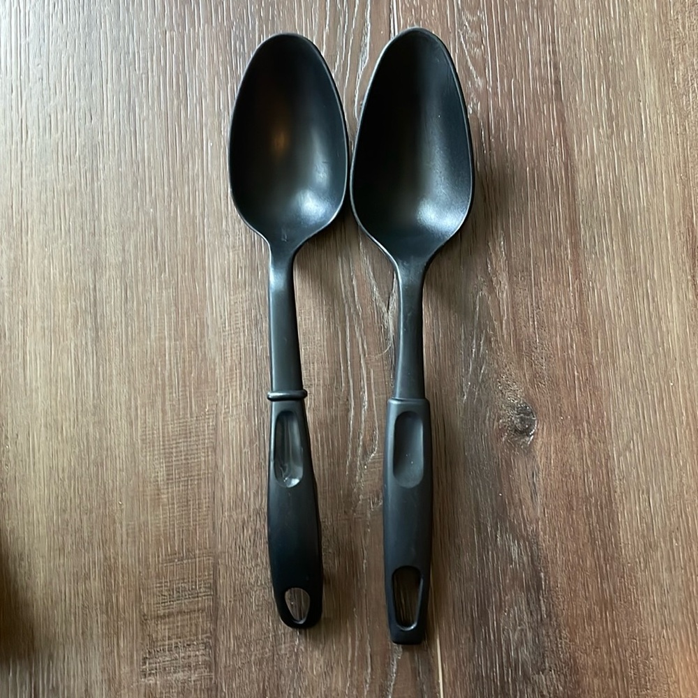 Two large black plastic cooking spoons